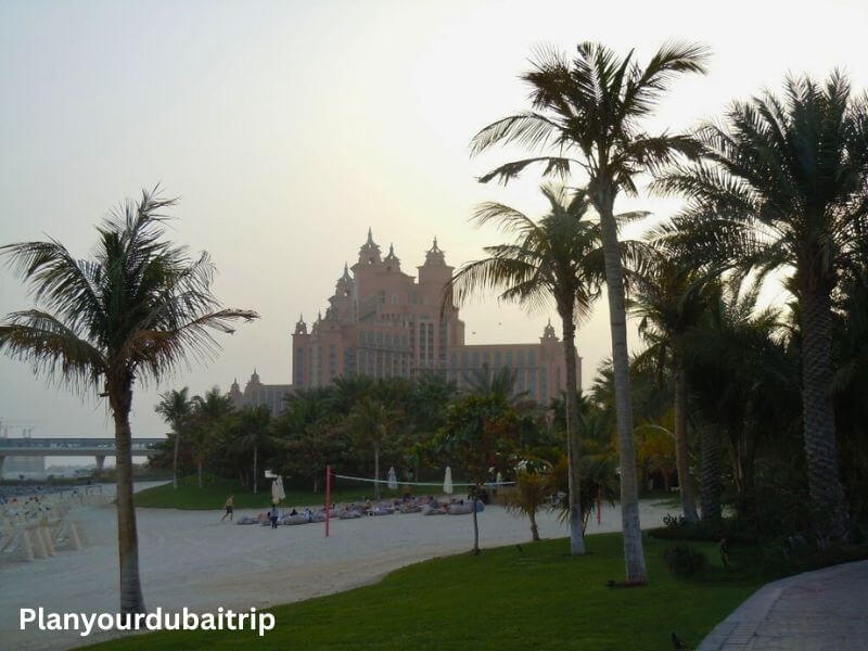 each area at Aquaventure Water Park in Dubai with palm trees and the pink Atlantis hotel visible in the background.
