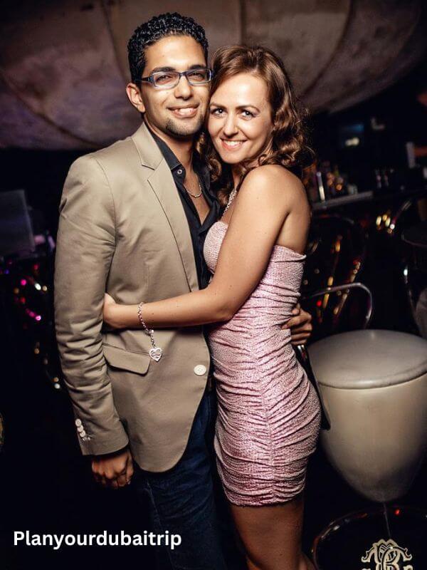 Cavalli Club Dubai Couple dressed up for a night out at Cavalli Club Dubai, posing together in the stylish club setting.