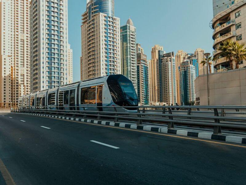 Dubai tram Dubai Tram passing between tall residential towers in the Marina and JBR area.