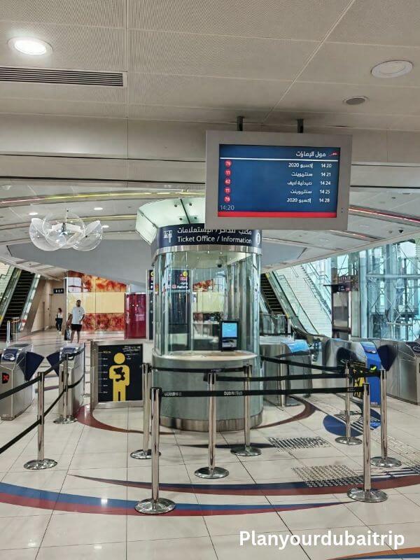 Ticket Office in Dubai metro Ticket office and information desk inside a Dubai Metro station, with ticket gates and an arrivals board above.